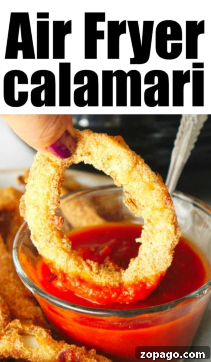 Crispy air fryer calamari rings served with dipping sauce, a perfect healthy appetizer.
