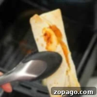 Perfectly cooked Ninja Foodi frozen burrito, showing its golden crisp exterior