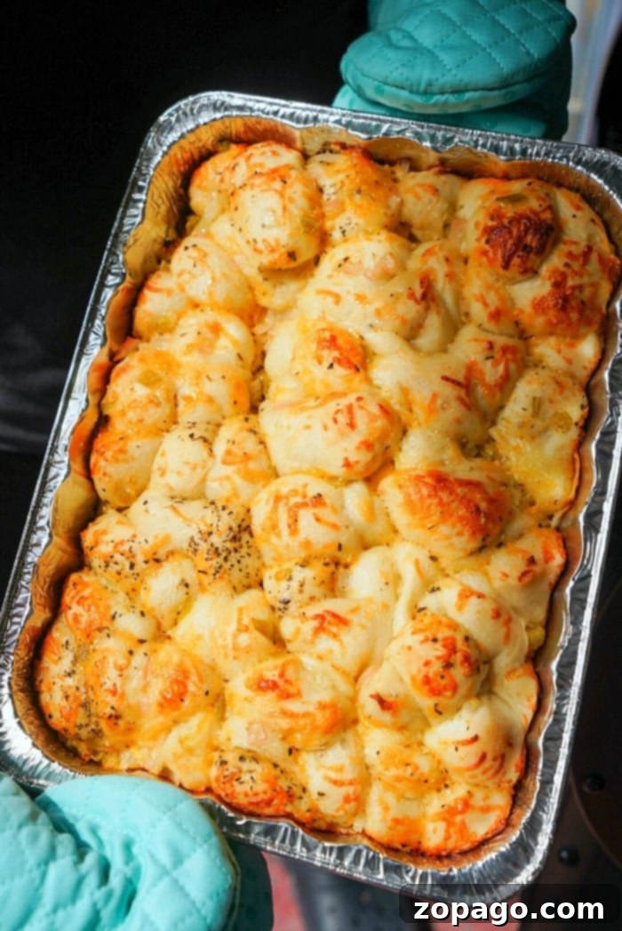 Smoky Traeger Pull-Apart Loaf 2 Golden-brown, cheesy pull-apart smoked bread fresh from the smoker, showcasing a delicious crust and soft interior.