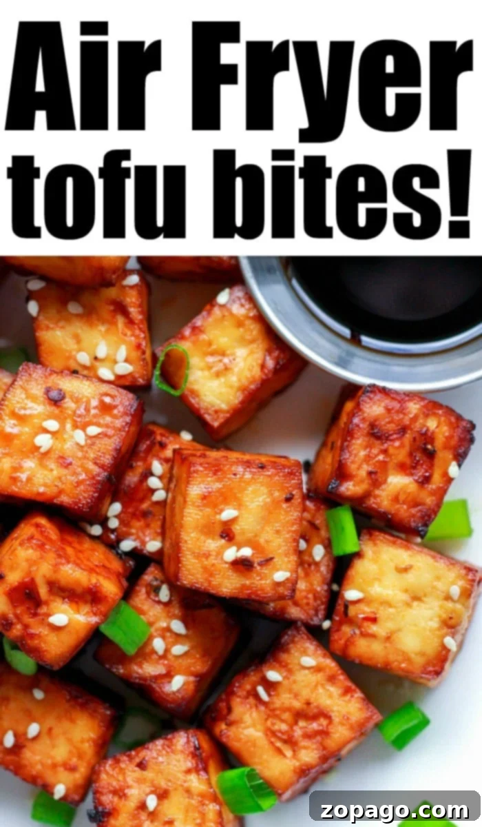 Flavorful Crispy Air Fryer Tofu 2 Crispy air fryer tofu bites with an Asian marinade, garnished with sesame seeds and green onions.