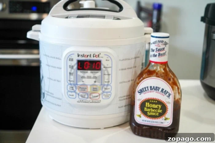 Tender Instant Pot BBQ Beef 4 Bottle of Sweet Baby Ray's BBQ sauce