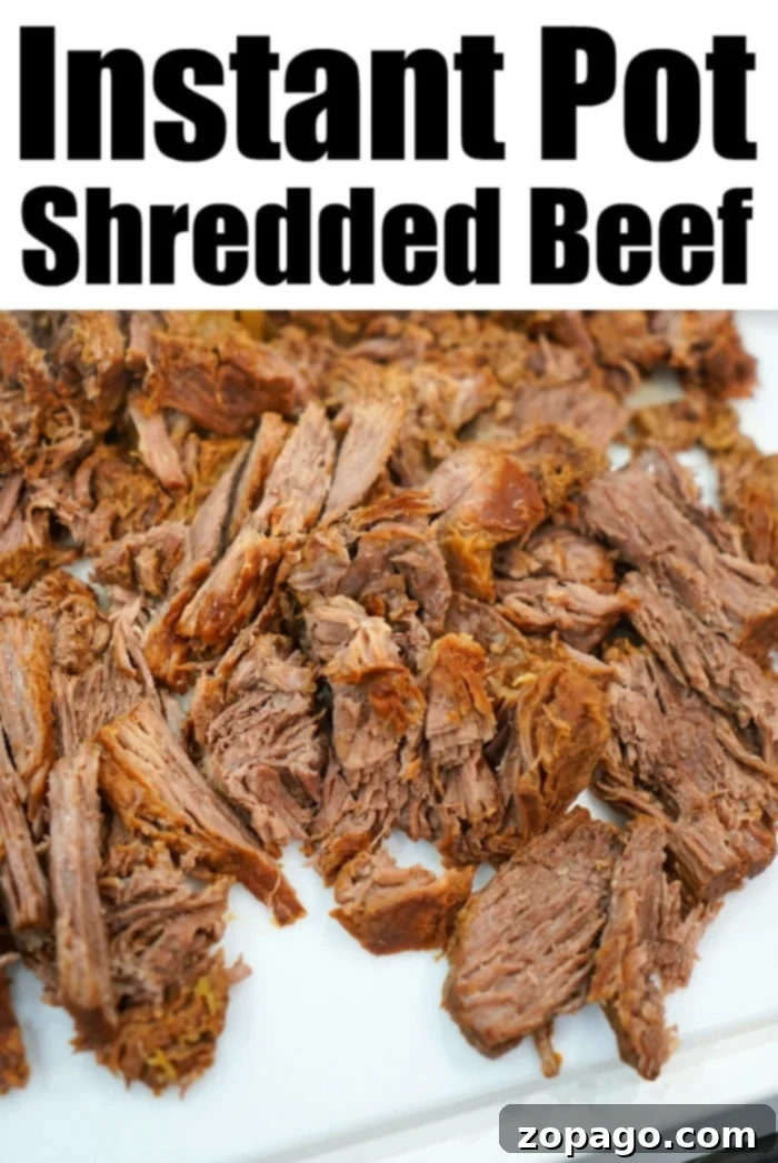 Tender Instant Pot BBQ Beef 7 Shredded beef on a white plate with Instant Pot BBQ Beef written above.