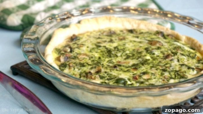 No-Fuss Spinach Quiche 8 A tantalizing slice of spinach quiche with a fork, ready to be enjoyed.