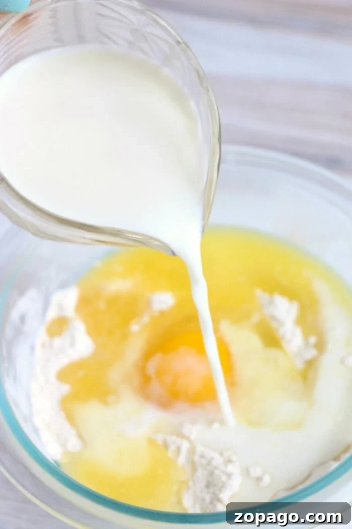 Homemade pancake batter being mixed in a bowl, ready for the mug.