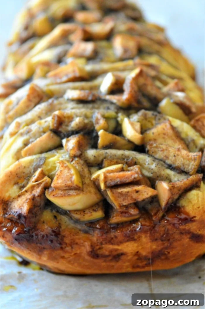 Sweet Cinnamon Pull-Apart Delight 8 Close-up of baked apple pull apart bread, showcasing its sticky, sweet layers and golden crust.