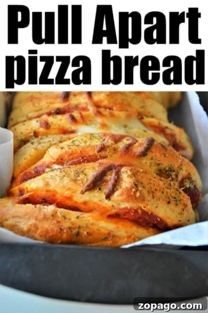 Pizza Monkey Bread 7 Golden brown pull apart pizza bread baked in a loaf pan, showing distinct slices filled with pepperoni and melted cheese, ready for serving.