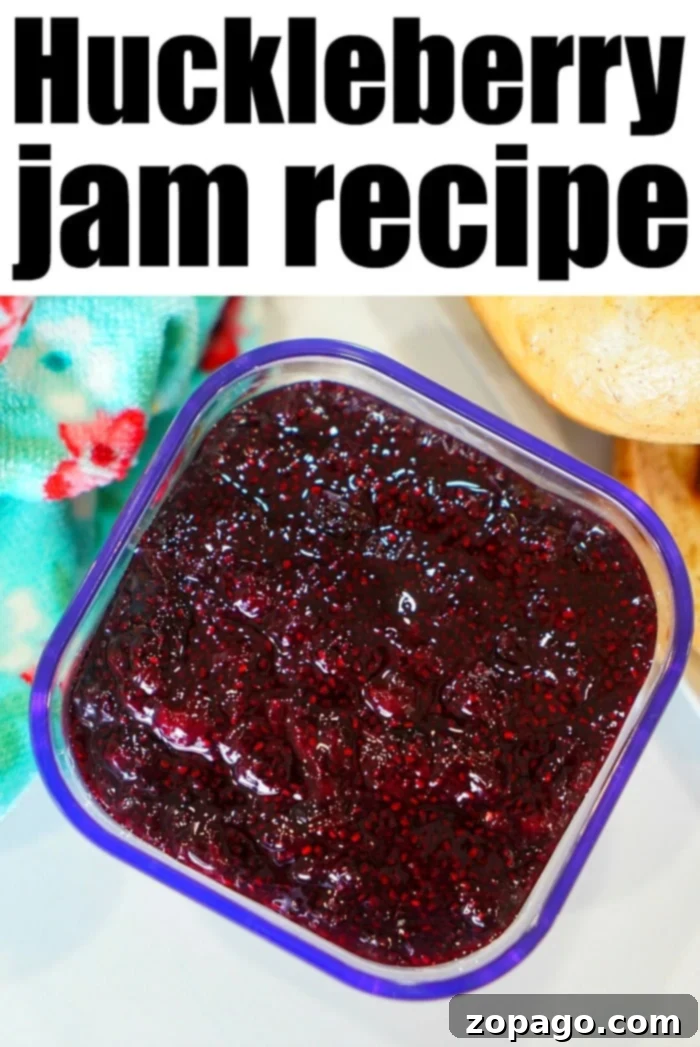 Huckleberry Delights 5 Two glass jars of homemade berry jam, glistening with rich, vibrant color, showcasing the delicious result of fresh huckleberry preserves.