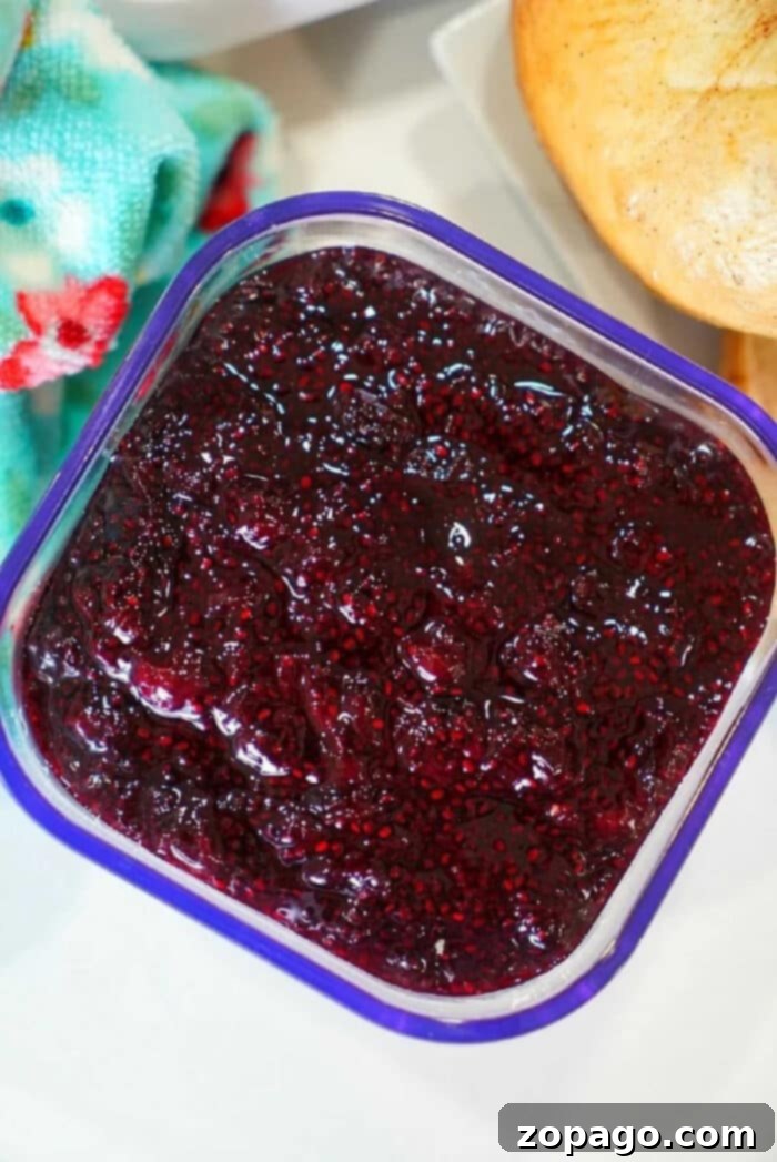 Wild Huckleberry Preserve 2 Rich purple huckleberry jam in a glass jar, ready to be spread.