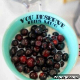 Blueberries in a teal mug make for the perfect topping to your simple overnight oats with yogurt.