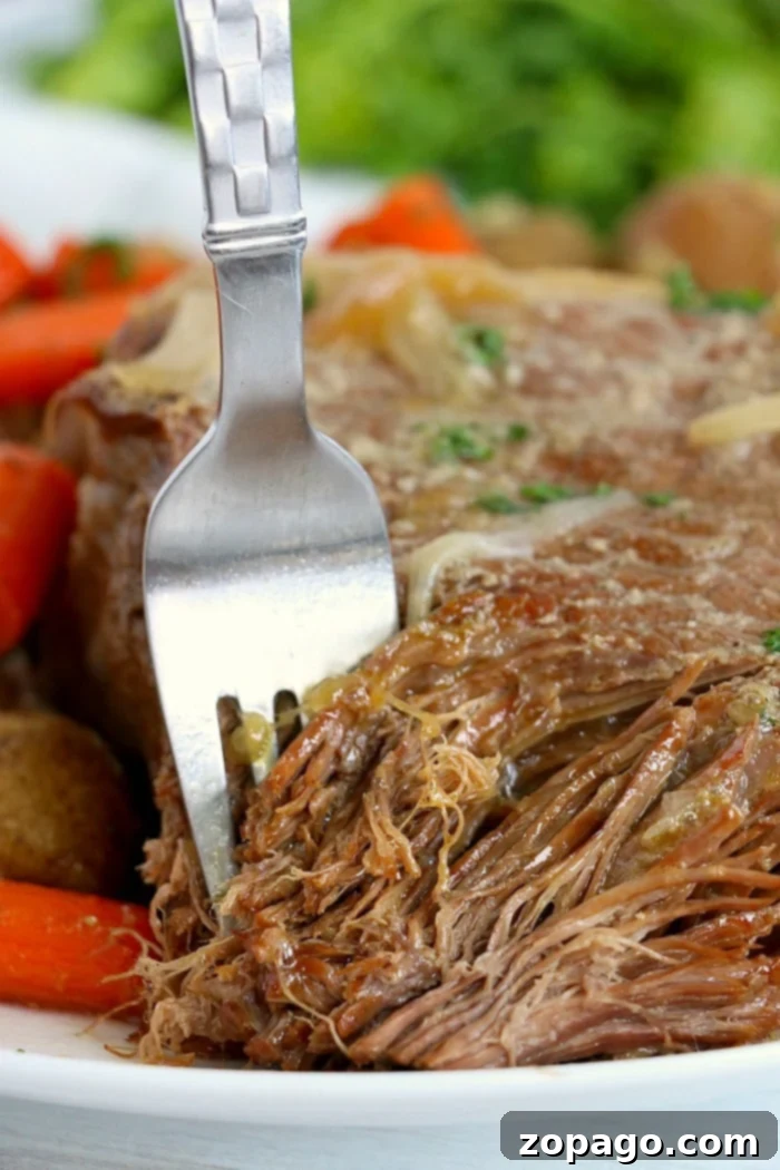 Ninja Foodi One-Pot Wonder 2 Tender Ninja Foodi pot roast with gravy, ready to be served.