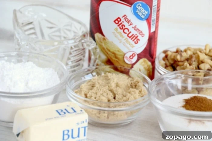 Easy Air Fryer Monkey Bread 4 Close-up of air fryer monkey bread ingredients on a wooden board: refrigerated biscuits, brown sugar, granulated sugar, cinnamon, and melted butter, ready for preparation.