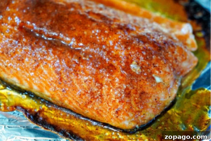 Zesty Herb Salmon Rub 7 A perfectly baked salmon fillet with a beautiful golden-brown dry rub crust, garnished with fresh herbs, showcasing the successful application of the seasoning.
