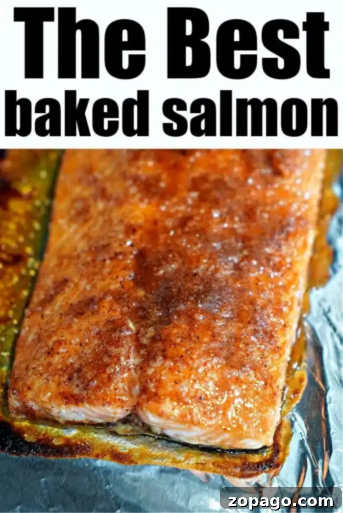 Ultimate Baked Salmon 8 A piece of the best baked salmon rests on a foil-lined surface, perfectly seasoned with spices. The text above declares "The Best Baked Salmon.