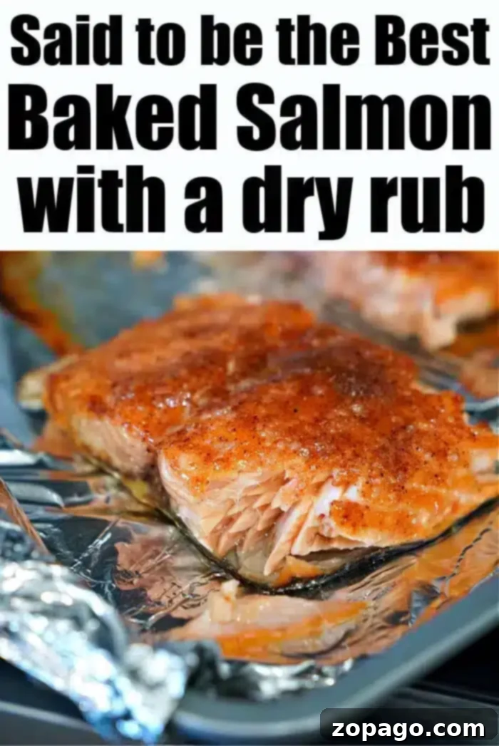 Ultimate Baked Salmon 9 A close-up view of the best baked salmon, perfectly seasoned with a savory dry rub, resting on a foil-lined baking sheet. The text on the image declares, "Said to be the Best Baked Salmon with a dry rub," emphasizing its irresistible quality.