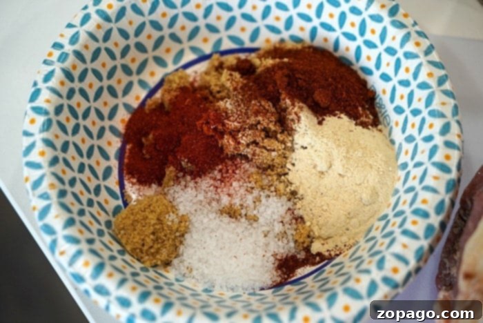 Petite Brisket Perfection 4 brisket dry rub - A close-up of a beef brisket generously coated with a savory and sweet dry rub mixture.