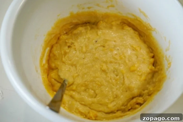 Surprising Mayonnaise Banana Bread 5 Thick, lumpy banana bread batter in a mixing bowl, ready to be poured into a pan.