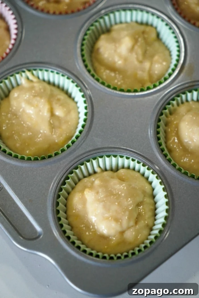 Surprising Mayonnaise Banana Bread 7 A large batch of freshly baked banana muffins, showcasing their golden-brown tops and moist texture, arranged invitingly.