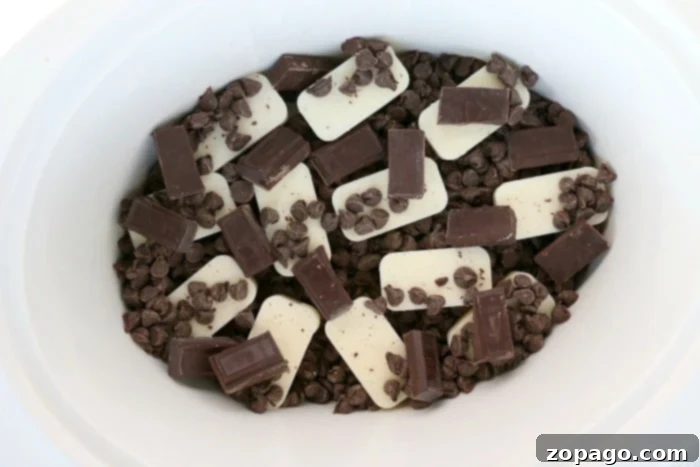 Slow Cooker Peanut Delights 5 Melted chocolate and peanuts in a slow cooker, transforming into chocolate clusters, with a spatula for stirring