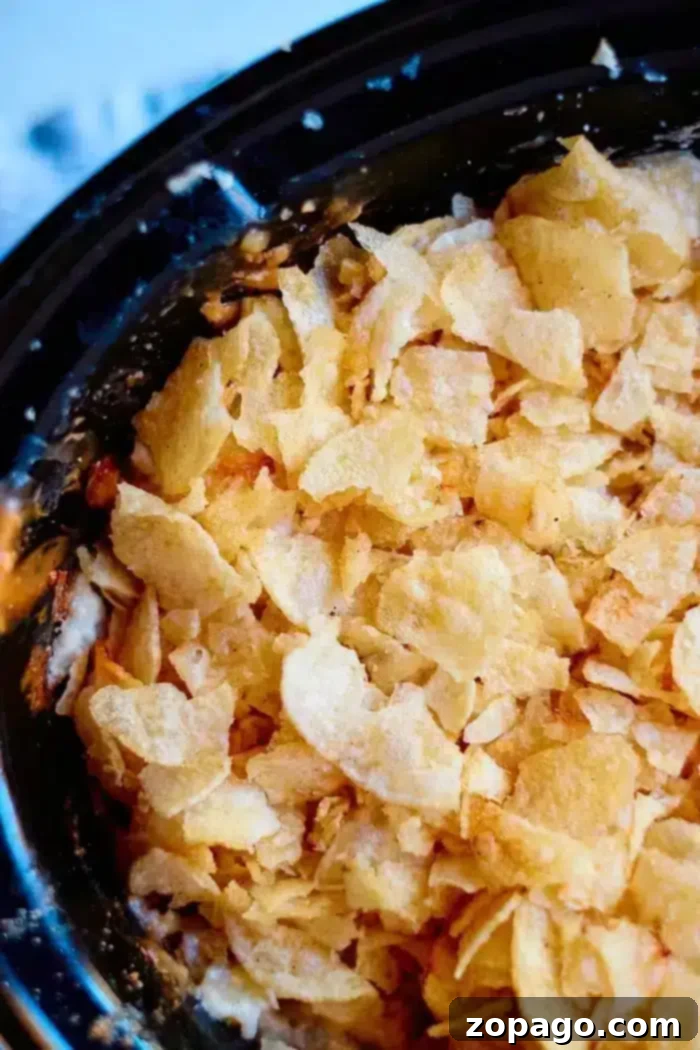 Crockpot Homestyle Cheesy Potato Bake 8 crockpot funeral potatoes with frozen hashbrowns and a golden brown, crispy topping ready to be served.