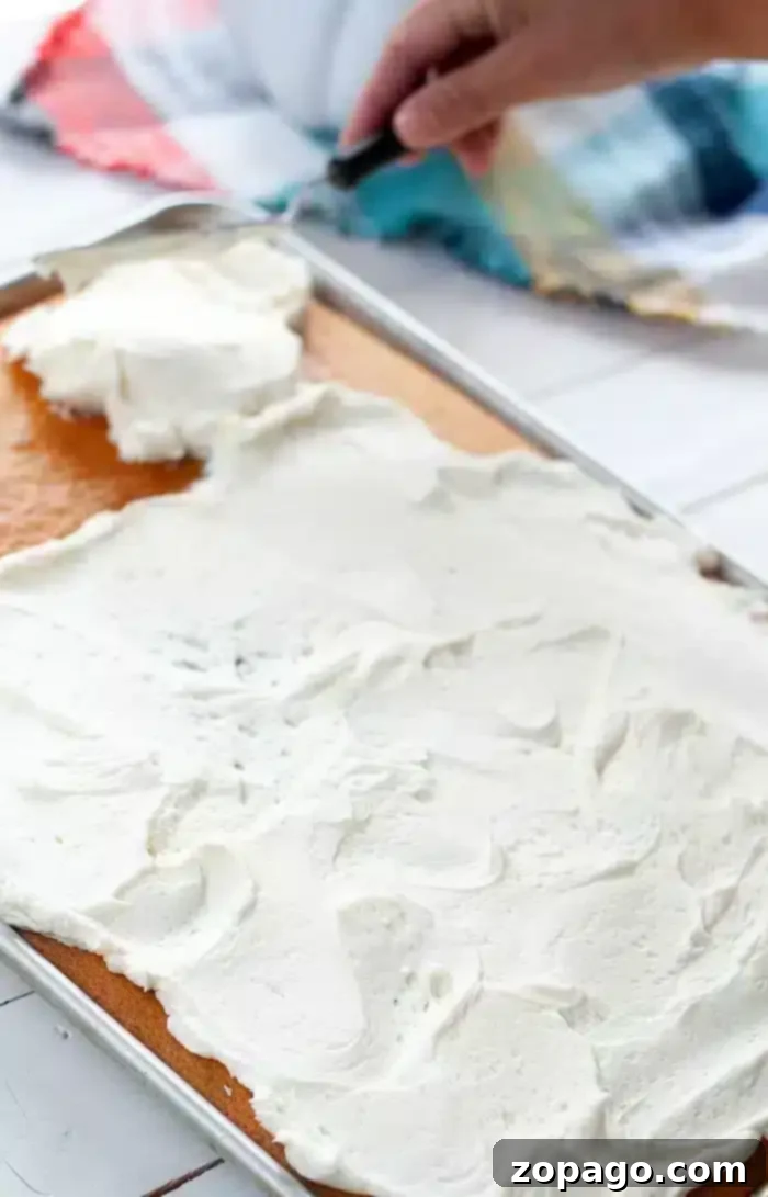 Half Sheet Cake Recipe 2 A freshly frosted half sheet cake with smooth white icing, ready to be served at a party.