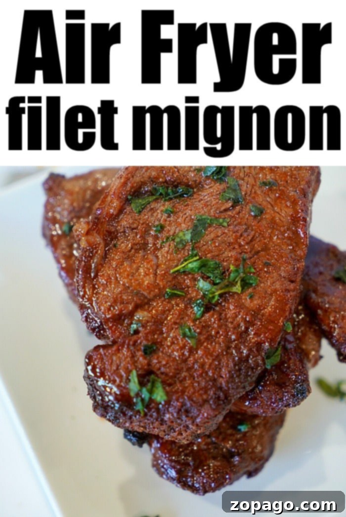 Air Fryer Filet Mignon Perfection 7 Two perfectly air-fried filet mignon steaks, sliced to reveal a medium-rare pink center, garnished with fresh herbs.