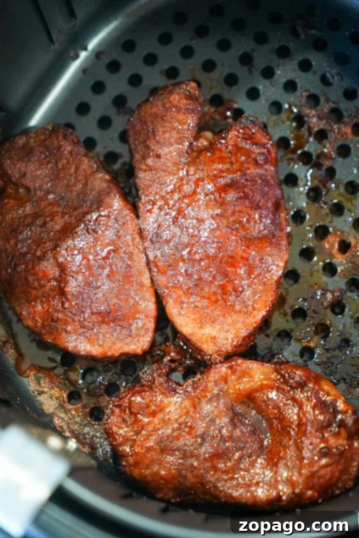 Air Fryer Filet Mignon Perfection 8 Three raw seasoned filet mignon steaks waiting in an air fryer basket next to a perfectly cooked, golden-brown filet mignon.
