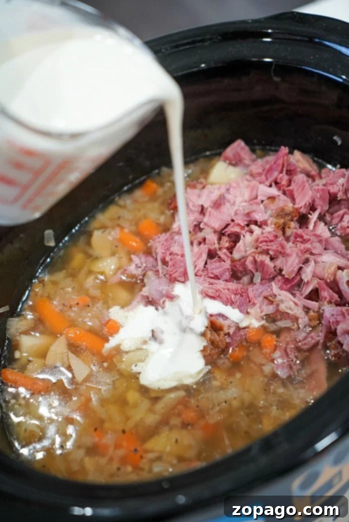 Hearty Slow Cooker Ham & Potato Chowder 5 Hearty ham and potato soup served in a bowl