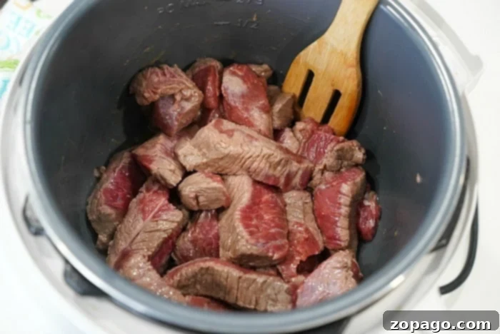 Instant Pot Mississippi Roast 9 Beef searing in olive oil in an Instant Pot on saute mode