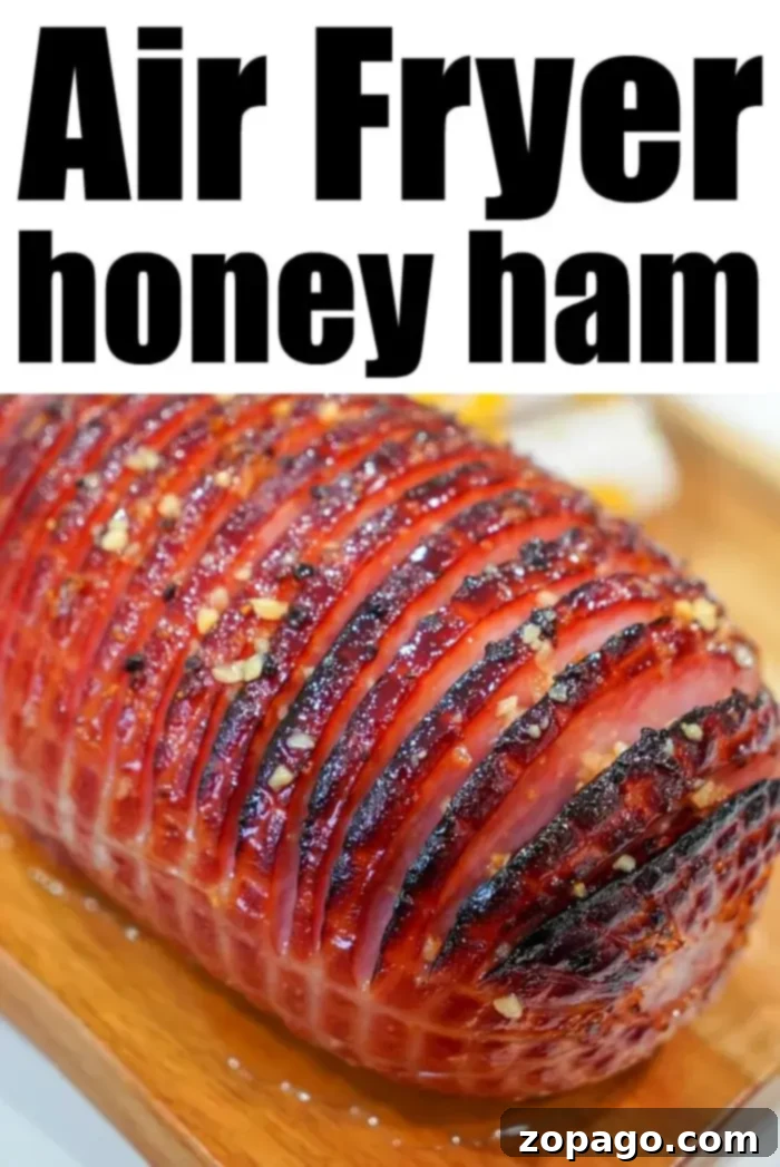 Perfect Air Fryer Ham 5 A close-up of a delectable honey-glazed air fryer ham, showcasing its perfectly caramelized exterior and enticing crosshatch pattern, cooked to perfection.