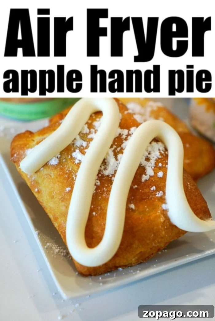 A close-up of an air-fried apple hand pie with icing drizzled on top, reminiscent of sweet air fryer dumplings.