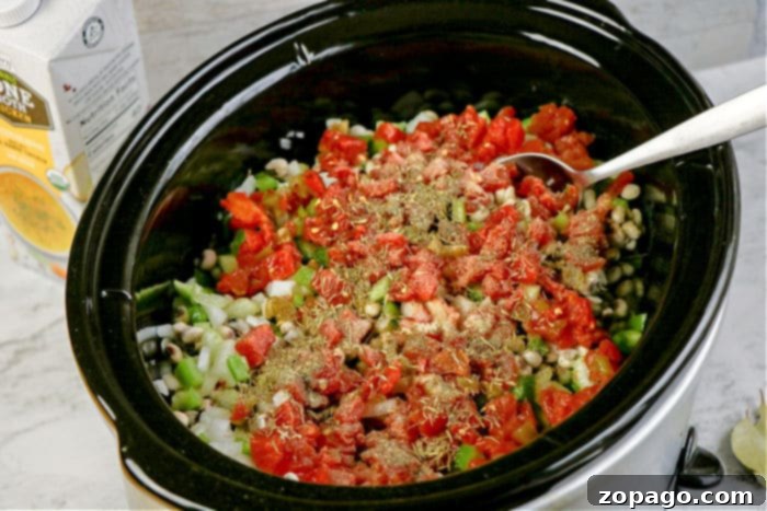 Effortless Slow Cooker Hoppin John 5 Serving spoonfuls of traditional Hoppin' John recipe into bowls