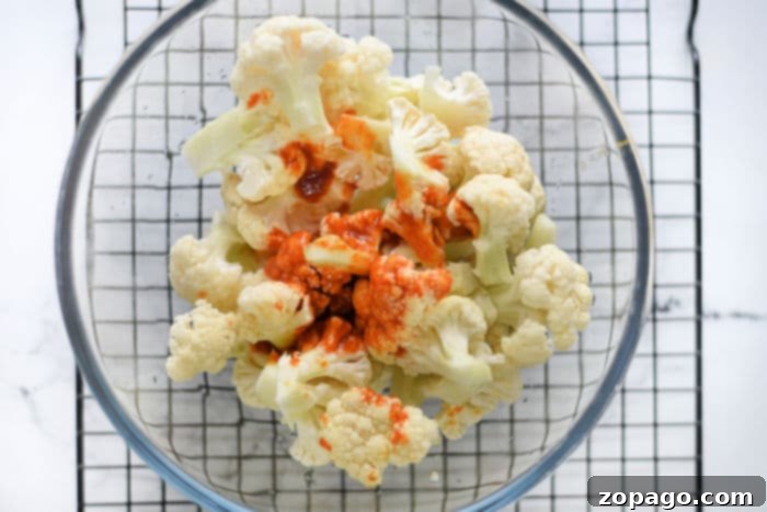 Crispy Buffalo Cauliflower Wings with Panko 5 cauliflower wings air fryer - A batch of golden, crispy buffalo cauliflower wings in an air fryer basket, ready to be served as a delicious snack.
