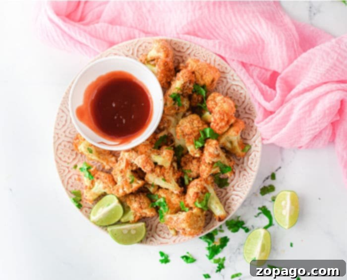 Crispy Buffalo Cauliflower Wings with Panko 8 ninja foodi cauliflower wings - A colorful platter of buffalo cauliflower wings, garnished with fresh herbs and served with dipping sauces, perfect for a party appetizer.