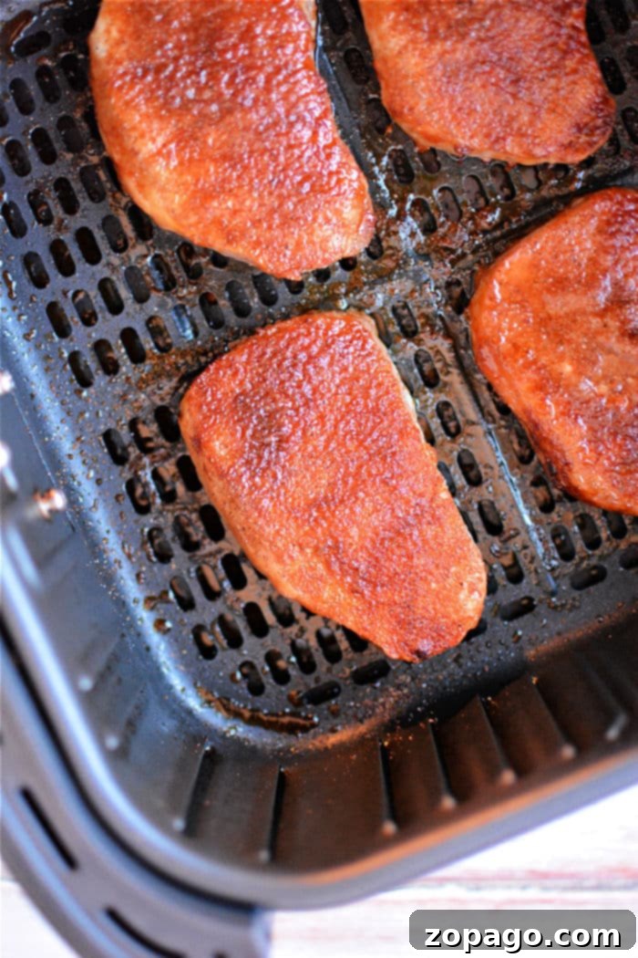No Thaw Air Fryer Pork Chops 7 Perfectly cooked, golden-brown frozen air fryer pork chops, ready to serve.