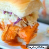 Instant Pot buffalo chicken slider with coleslaw elegantly presented on a square white plate.