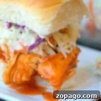 Instant Pot buffalo chicken slider with coleslaw elegantly presented on a square white plate.
