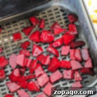 Air fryer beets are ready for cooking as chopped beets fill the basket, promising a delicious and healthy treat.