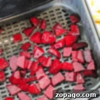Air fryer beets are ready for cooking as chopped beets fill the basket, promising a delicious and healthy treat.