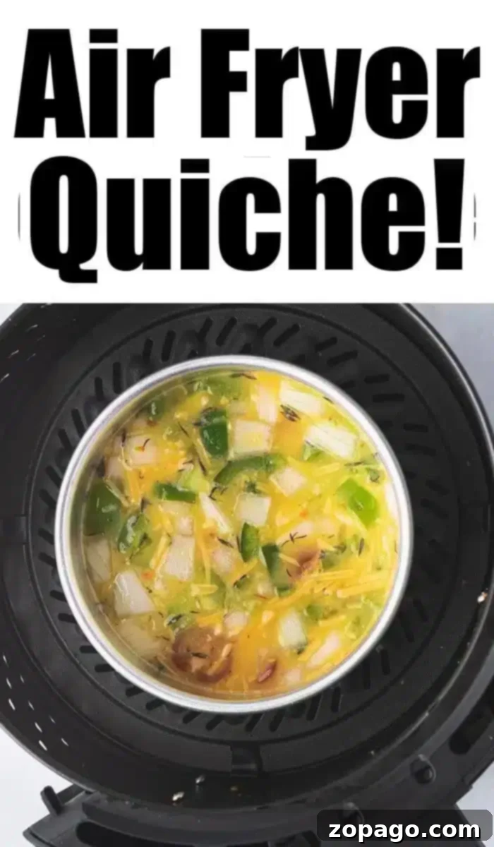 Air Fryer Quiche Perfection 7 A delicious air fryer quiche with vibrant vegetables is cooking to perfection. Overhead, bold text proudly announces "Air Fryer Quiche!