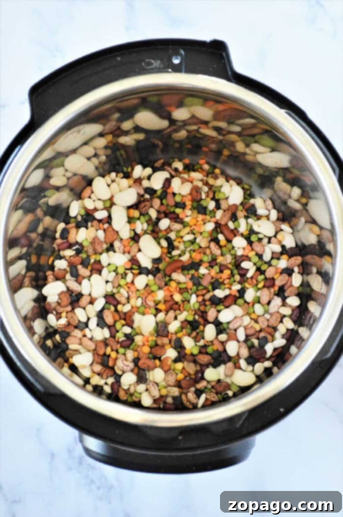 Hearty Instant Pot 15 Bean Soup 5 Instant Pot 15 bean soup sits invitingly on a marble countertop, showcasing its hearty mix of flavors and rich textures.