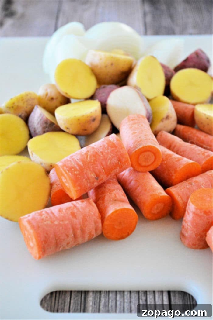 Slow Cooker Frozen Roast 6 Close-up of fresh carrots and potatoes, diced and ready for the slow cooker.