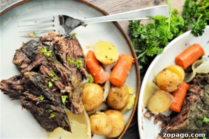 Slow Cooker Frozen Roast 10 Roast recipe showing a serving of tender slow cooker beef and vegetables.
