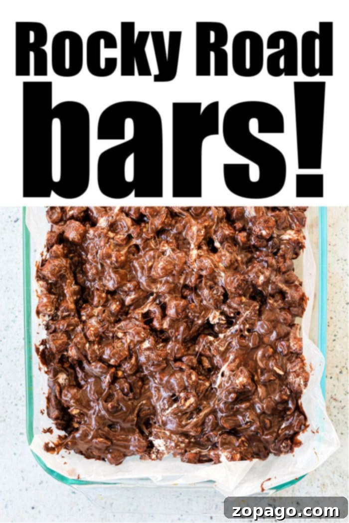 Fudgy No-Bake Marshmallow Bars 6 A perfectly cut rocky road bar, showing layers of chocolate, marshmallows, and nuts.