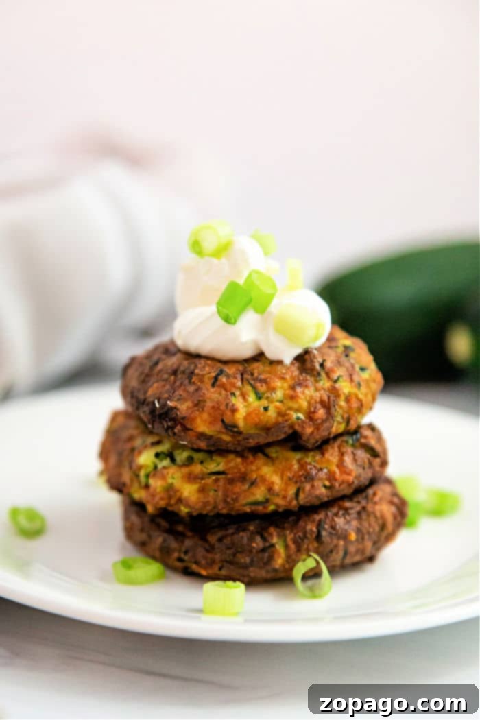 Crispy Air Fryer Zucchini Ideas 7 Crispy air fryer zucchini fritters served with a dollop of sour cream.