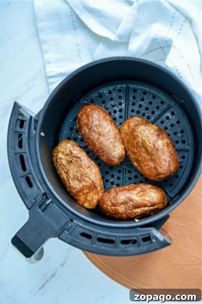 Crispy Air Fryer Potato Skins 3 Freshly baked potatoes, ready to be transformed into crispy air fryer potato skins