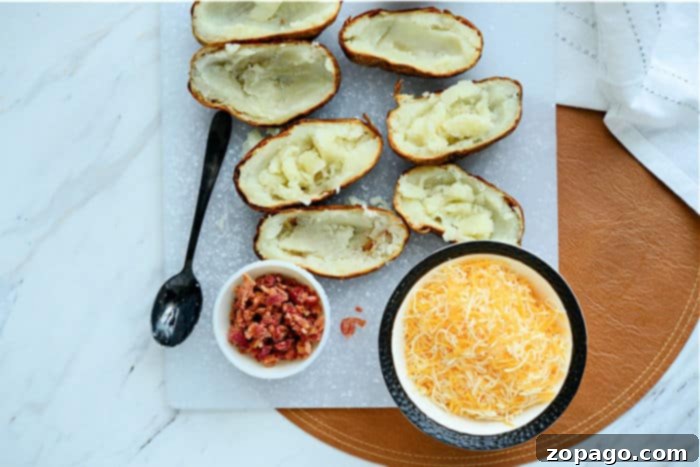 Crispy Air Fryer Potato Skins 4 Two halves of twice stuffed potatoes, featuring creamy filling and melted cheese