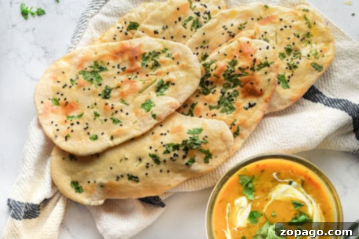 Homemade Air Fryer Naan Bread 10 A stack of golden, soft naan bread, ready to eat, highlighting an easy naan bread recipe.