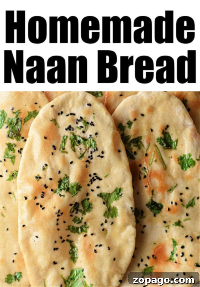 Homemade Air Fryer Naan Bread 7 A serving of homemade naan bread, brushed with butter and sprinkled with herbs, on a wooden board.