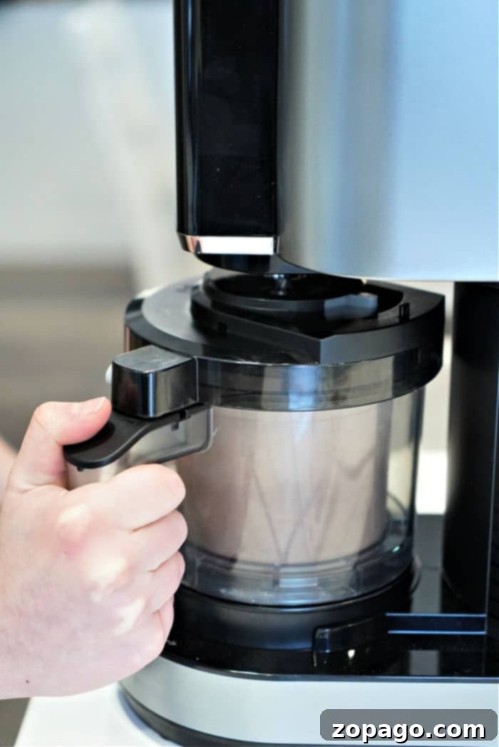 Your Ninja Creami Frozen Dessert Studio 6 Ninja Creami machine on a countertop, processing a dessert.