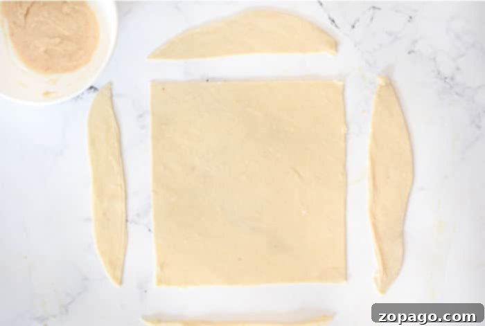 Whip Up Perfect Homemade Egg Roll Wrappers 5 Thinly rolled and accurately cut homemade egg roll wrappers, showing their perfect square shape.